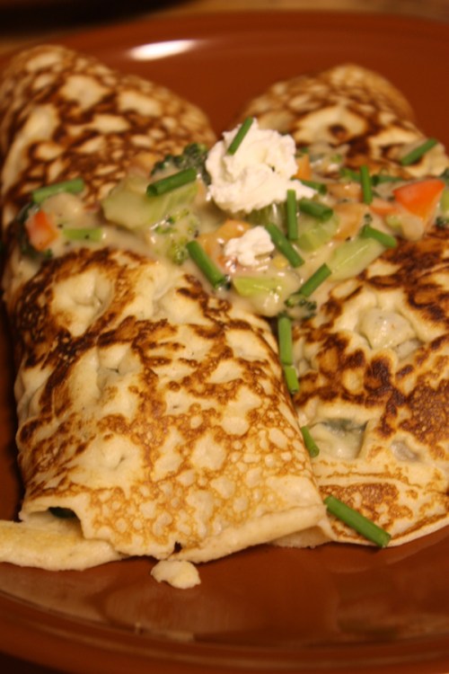crepes stuffed with veggies in goat cheese cream sauce